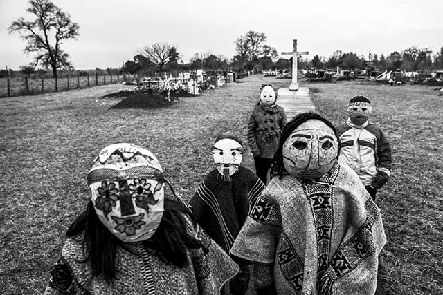 bambini in cimitero con maschere sul viso