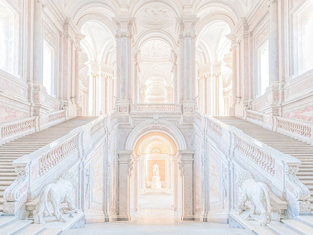 Patrizia Mussa Milano foto a colori di interno di palazzo antico con scalinate laterali grandi vetrate e statue di leoni