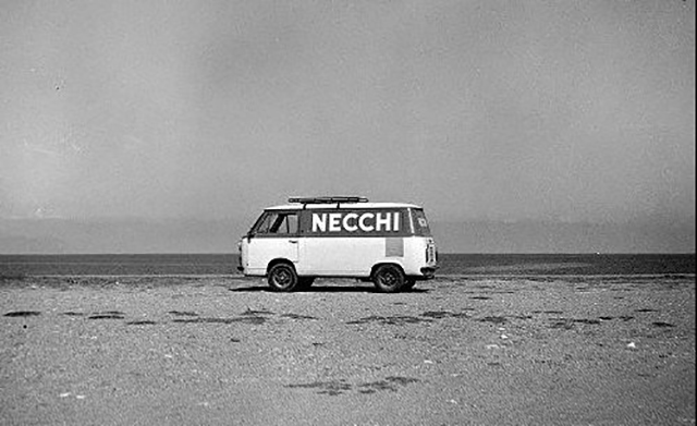 Carlo Riggi Milano foto in bianco e nero di pulmino con scritta Necchi parcheggiato sulla spiaggia