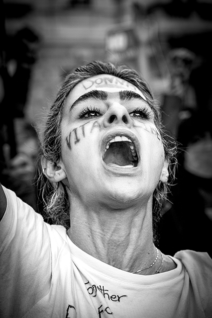 Colornophotolife 2023 Colorno foto in bianco e nero di primo piano di donna che urla ad una manifestazione con scritte sul viso